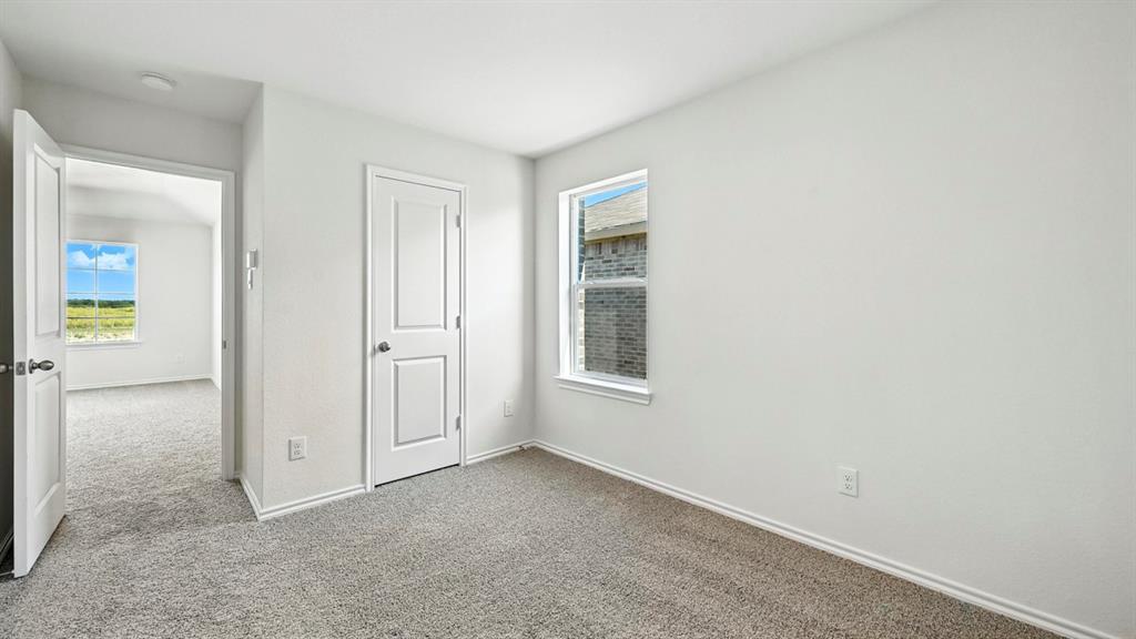 122 Pheasant Run Road Terrell, TX 75160 - Photo 12 of 36 Carpeted room featuring white walls, white trim, and a window providing natural light
