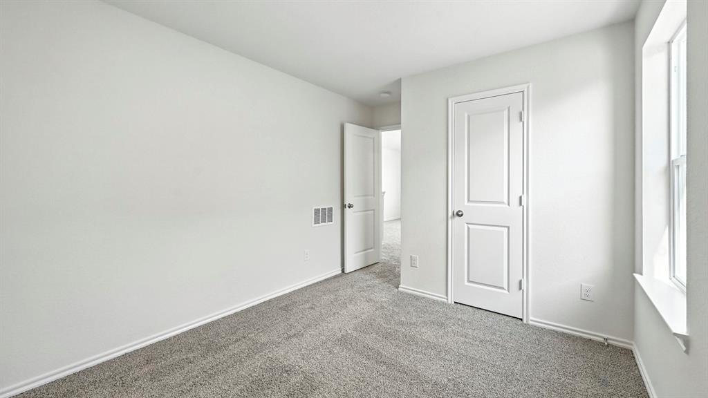 122 Pheasant Run Road Terrell, TX 75160 - Photo 13 of 36 Neutral-toned interior room featuring light gray carpeting and white trim