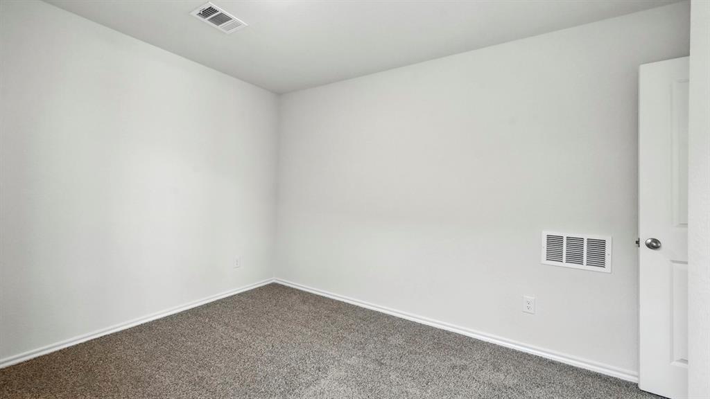 122 Pheasant Run Road Terrell, TX 75160 - Photo 14 of 36 Room featuring light-colored walls, gray carpet, and white trim