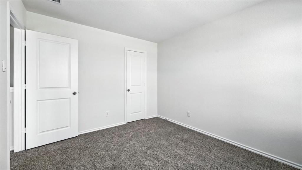 122 Pheasant Run Road Terrell, TX 75160 - Photo 15 of 36 Neutral interior space featuring light-toned walls and dark gray carpeting