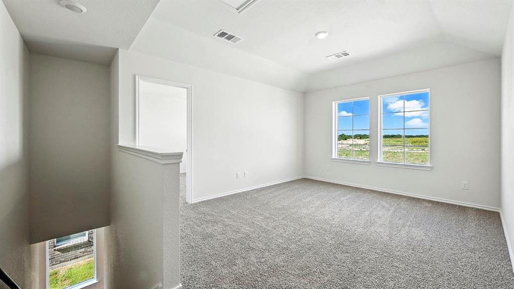 122 Pheasant Run Road Terrell, TX 75160 - Photo 26 of 36 Spacious upper-level room featuring two prominent windows, plush gray carpeting, and recessed lighting