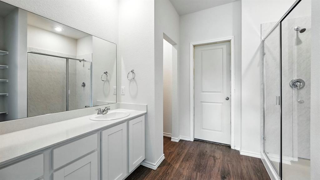 122 Pheasant Run Road Terrell, TX 75160 - Photo 2 of 36 Bathroom featuring a vanity with an integrated sink, white cabinetry, and a large mirror