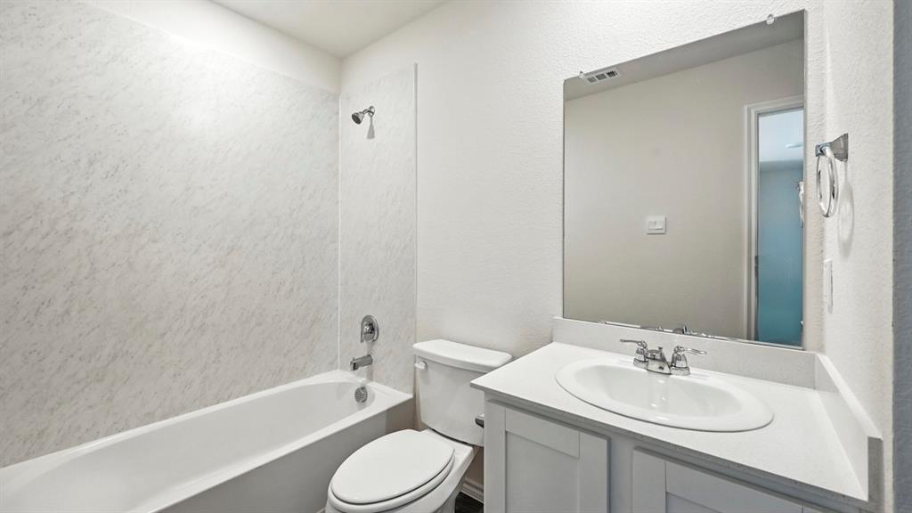 122 Pheasant Run Road Terrell, TX 75160 - Photo 5 of 36 Full bathroom featuring a white tub, coordinating shower surround, and a white vanity with a single basin sink