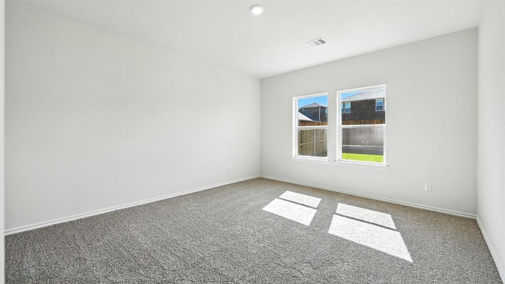 122 Pheasant Run Road Terrell, TX 75160 - Photo 7 of 36 Room featuring two windows, neutral gray carpeting, white painted walls, and white trim