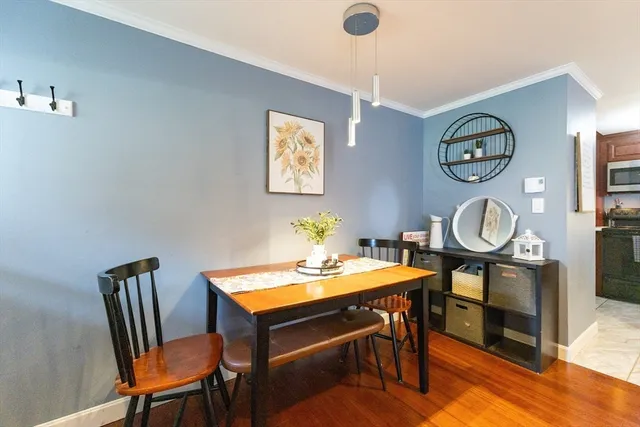 a dining room with furniture and a mirror
