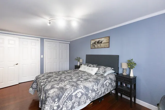 a bedroom with a bed and a painting on the wall