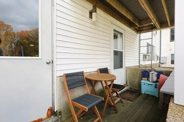 a balcony with table and chairs