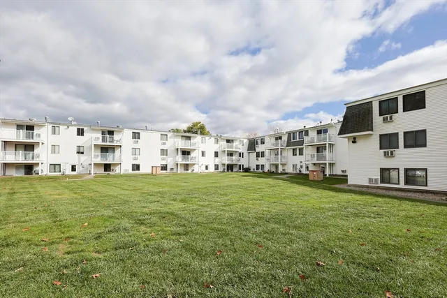 a view of a building with garden and bench