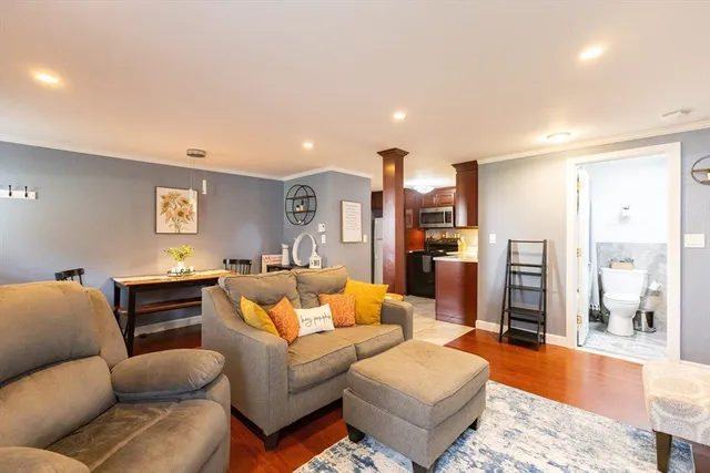 a living room with furniture and wooden floor