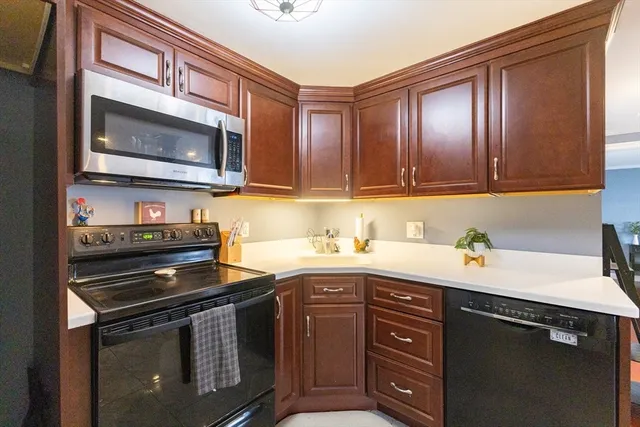 a kitchen with stainless steel appliances granite countertop a stove a sink and a microwave