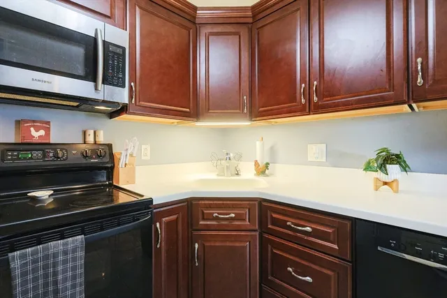 a kitchen with stainless steel appliances granite countertop a stove and a microwave