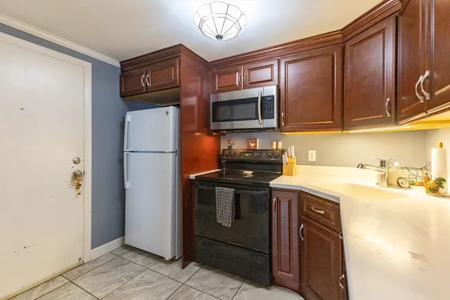 a kitchen with stainless steel appliances granite countertop a refrigerator stove and sink