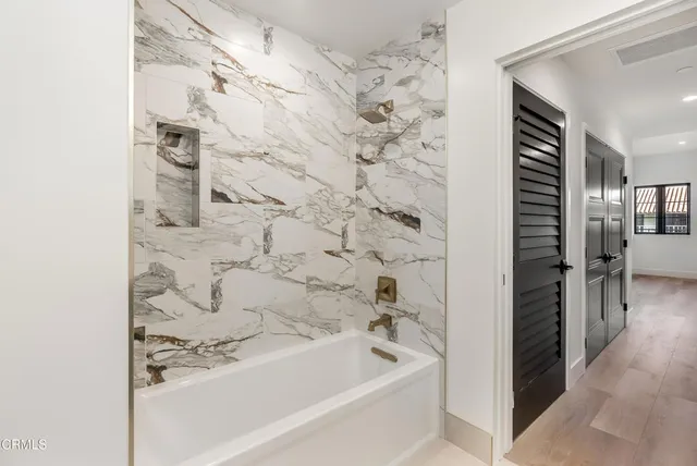 a bathroom with a bathtub and a shower