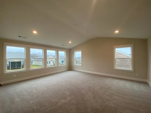 an empty room with a empty space and windows