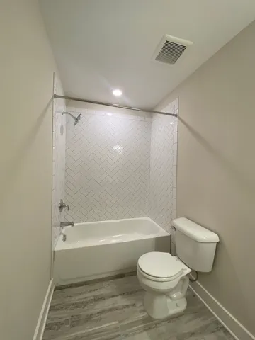 a bathroom with a toilet and a bath tub
