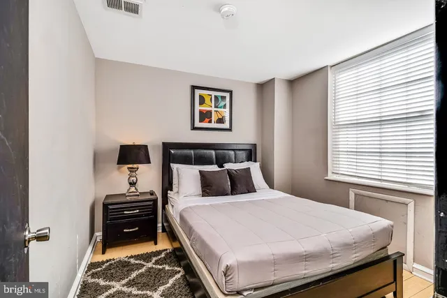 a bedroom with a bed and a dresser