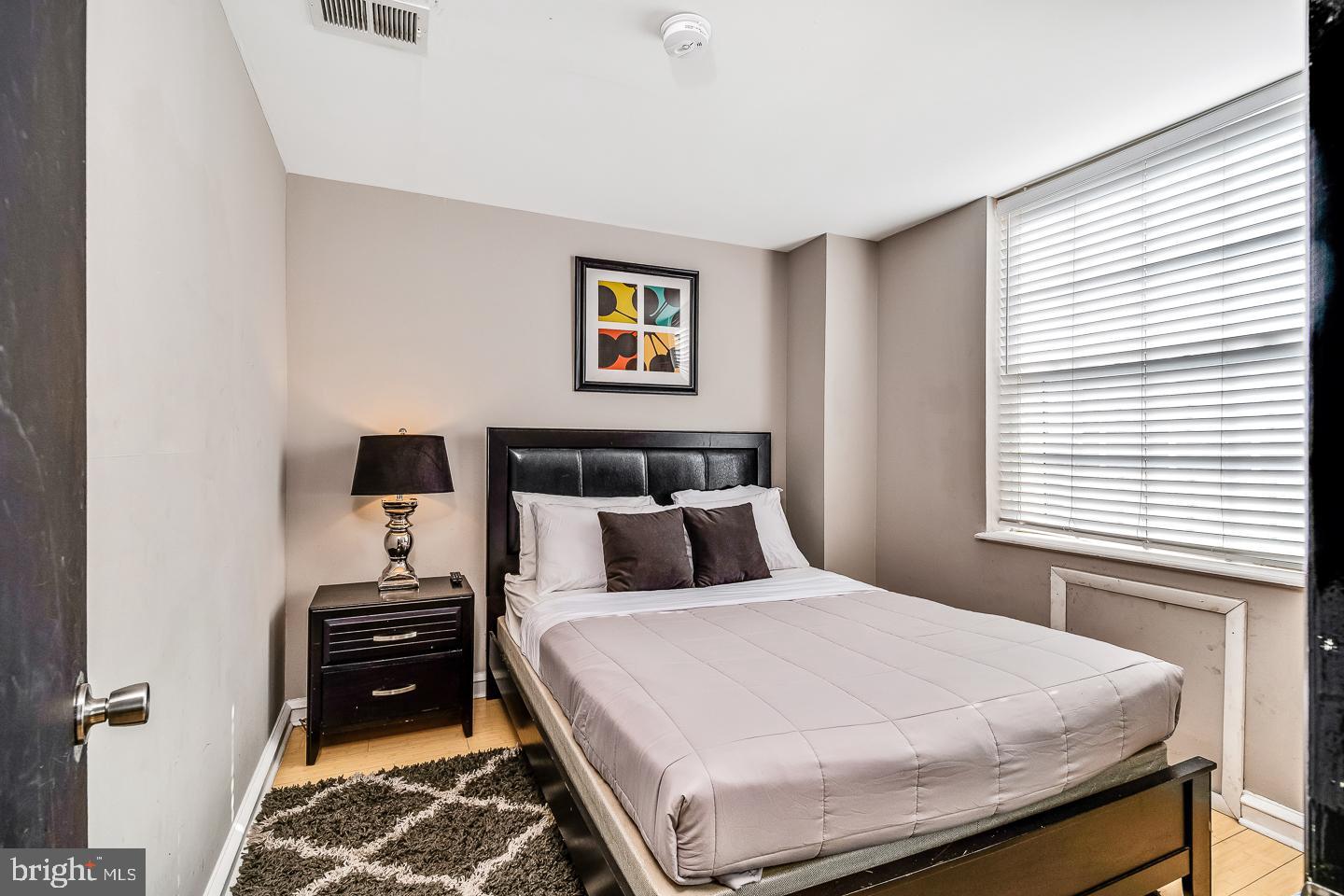 2135 Walnut Street, Unit 603 Philadelphia, PA 19103 - Photo 2 of 13 a bedroom with a bed and a dresser