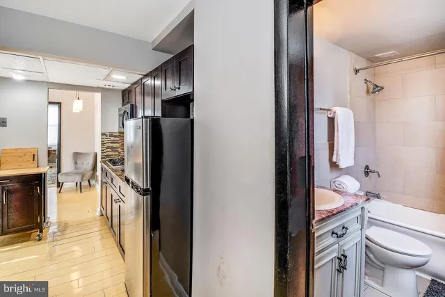 a bathroom with a double vanity sink toilet and shower