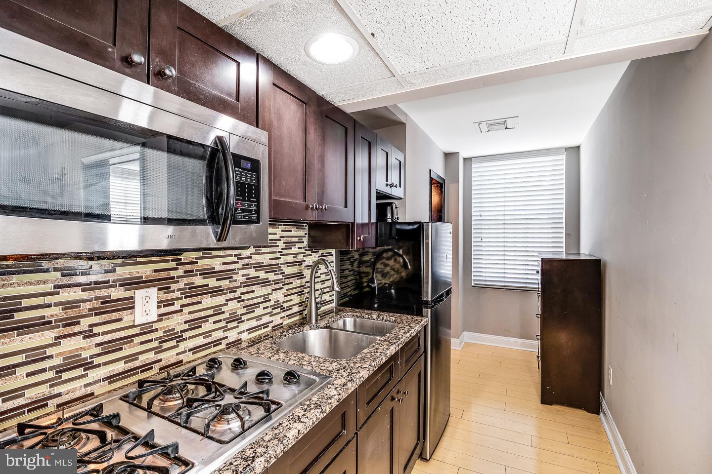 2135 Walnut Street, Unit 603 Philadelphia, PA 19103 - Photo 6 of 13 a kitchen with a stove and a refrigerator
