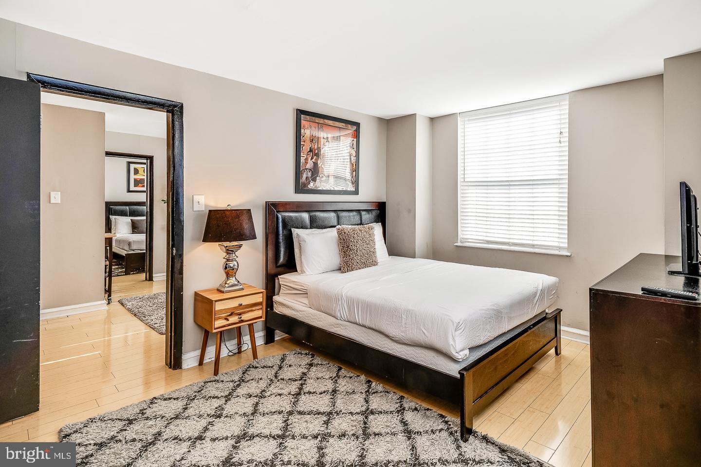 2135 Walnut Street, Unit 603 Philadelphia, PA 19103 - Photo 7 of 13 a bedroom with a bed and wooden floor