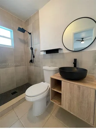 a bathroom with a sink a toilet and a mirror