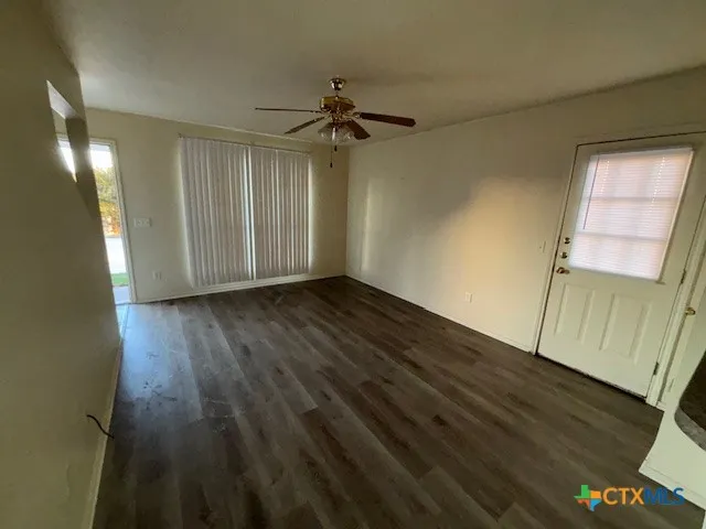 wooden floor in an empty room with a window