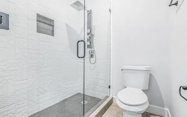 a bathroom with a granite countertop sink a toilet and mirror