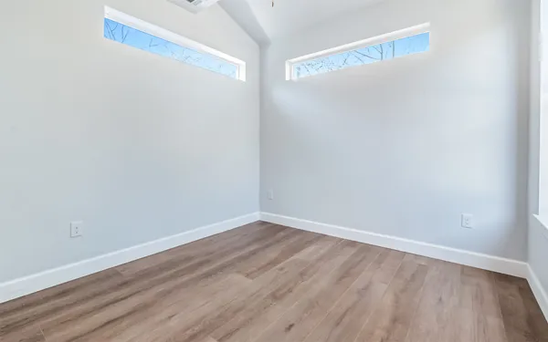 a bedroom with a bed and a potted plant