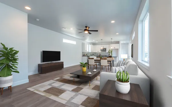 a living room with furniture a window and a flat screen tv