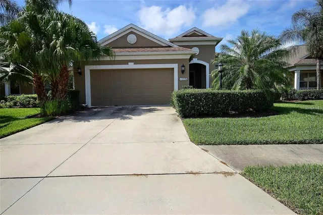 a front view of a house with a yard and garage