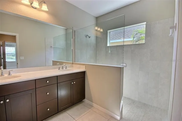 a bathroom with a double vanity sink and mirror