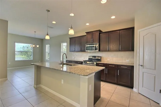 a large kitchen with stainless steel appliances lots of counter top space