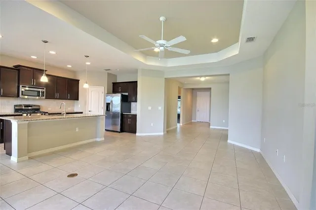 a large kitchen with stainless steel appliances lots of counter space and a sink