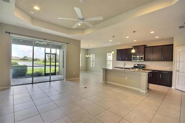 a large kitchen with stainless steel appliances granite countertop a large stove top oven and cabinets
