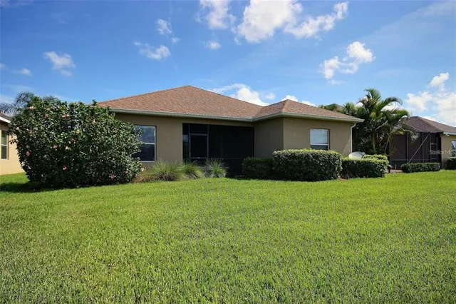a view of living room filled with furniture and floor to ceiling windows
