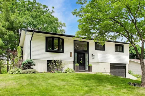 a front view of a house with a garden