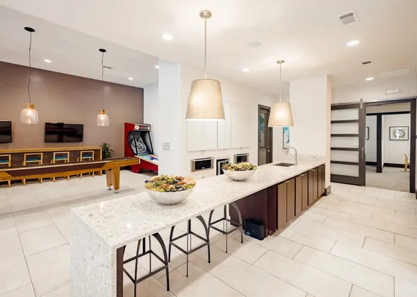a kitchen with stainless steel appliances kitchen island granite countertop a sink and cabinets