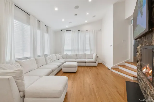 a large kitchen with stainless steel appliances granite countertop a lot of counter space and wooden floors