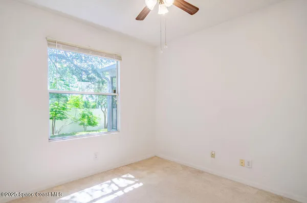 a view of a livingroom with a chandelier fan