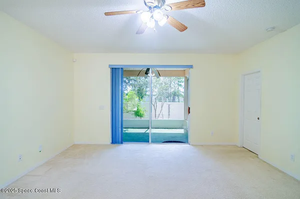 a view of a livingroom with a ceiling fan and window