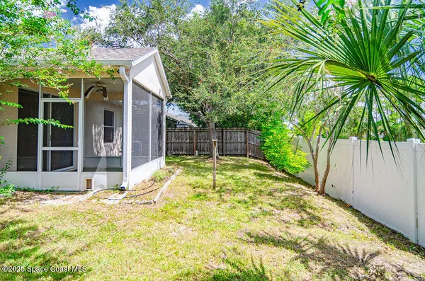 a backyard of a house with table and chairs