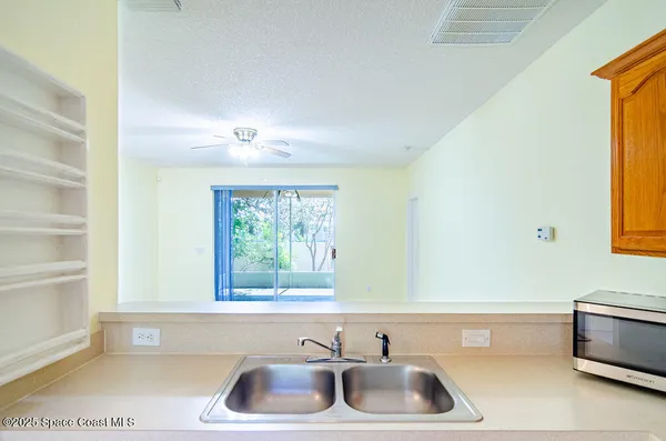 a kitchen with stainless steel appliances a refrigerator sink and cabinets