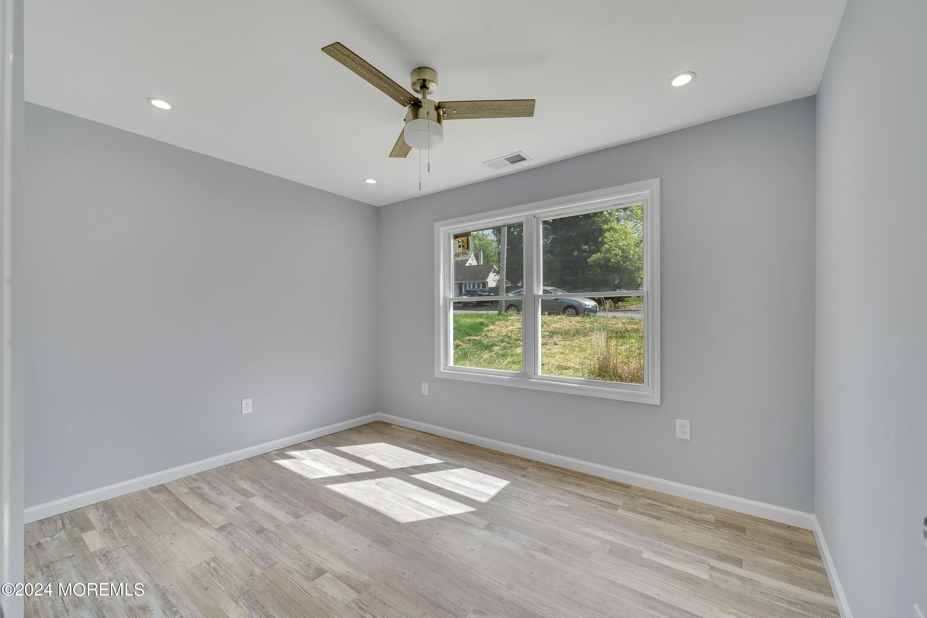 36 Pine Tree Road Old Bridge, NJ 08857 - Photo 24 of 34 a view of empty room with wooden floor and fan