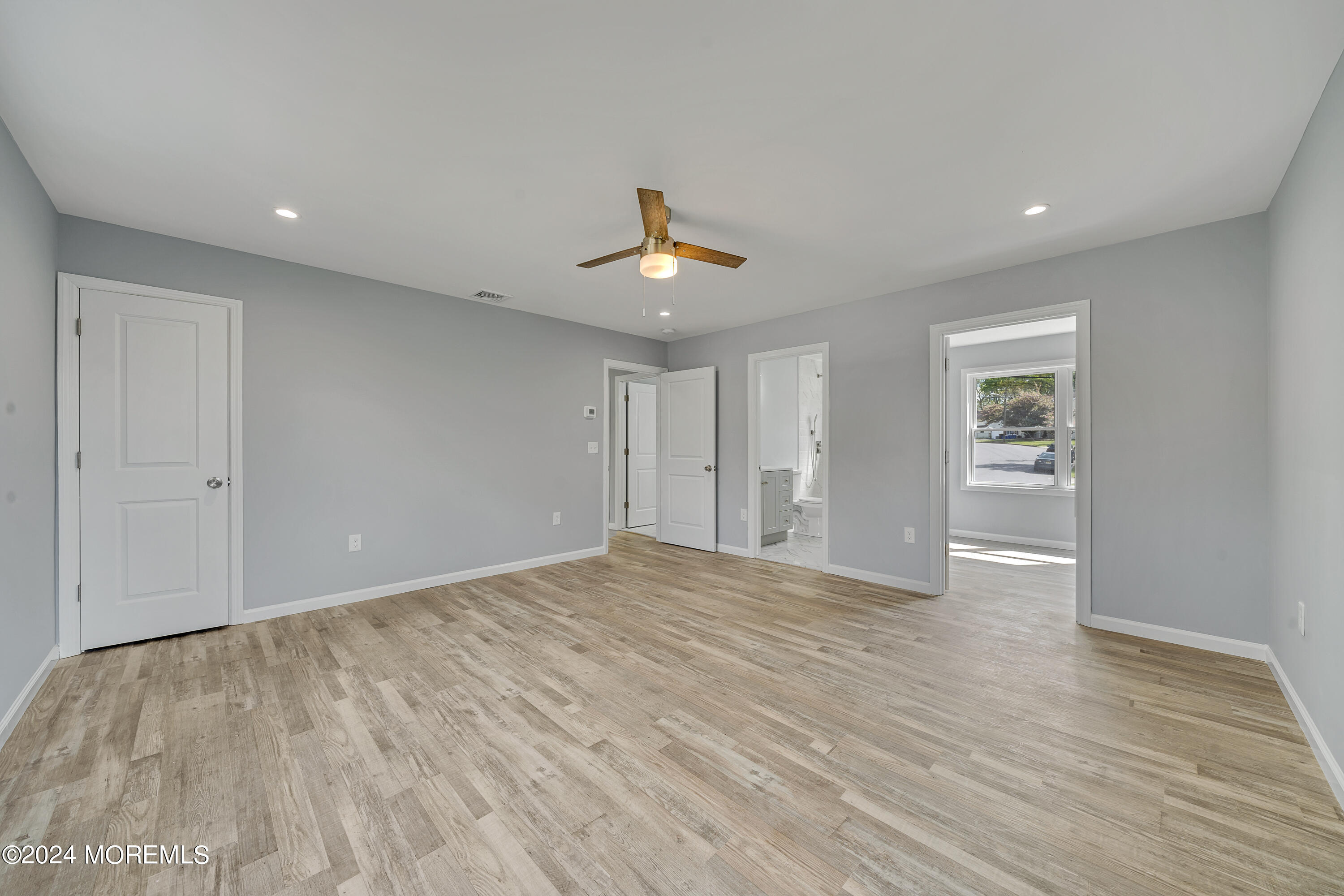 36 Pine Tree Road Old Bridge, NJ 08857 - Photo 34 of 34 a view of an empty room with wooden floor and a ceiling fan