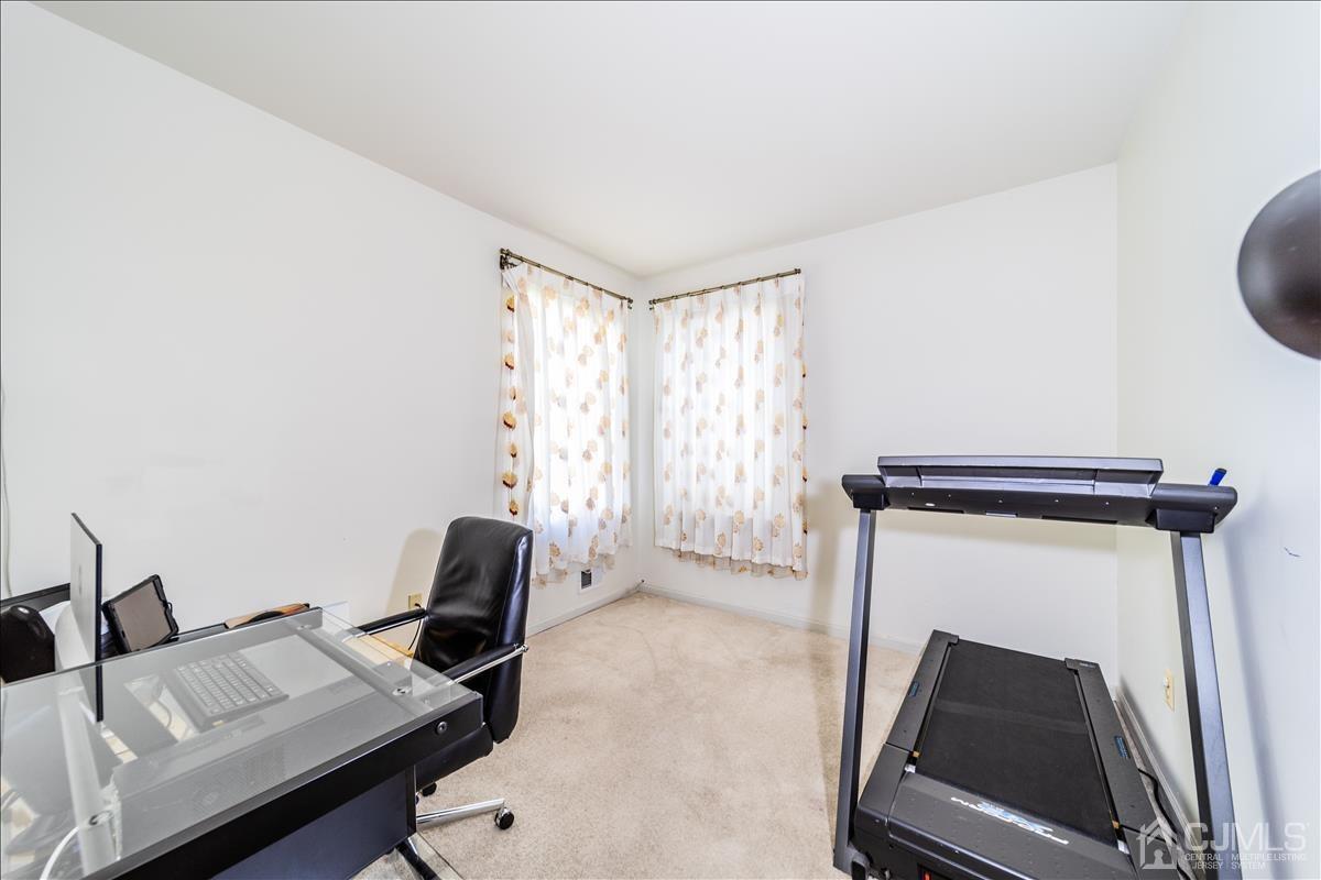 46 Potomac Road Monmouth Junction, NJ 08852 - Photo 16 of 42 a living room with a bed and a chair