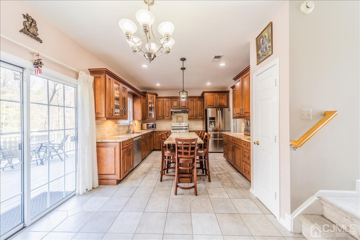 46 Potomac Road Monmouth Junction, NJ 08852 - Photo 18 of 42 a view of a kitchen with furniture and chandelier