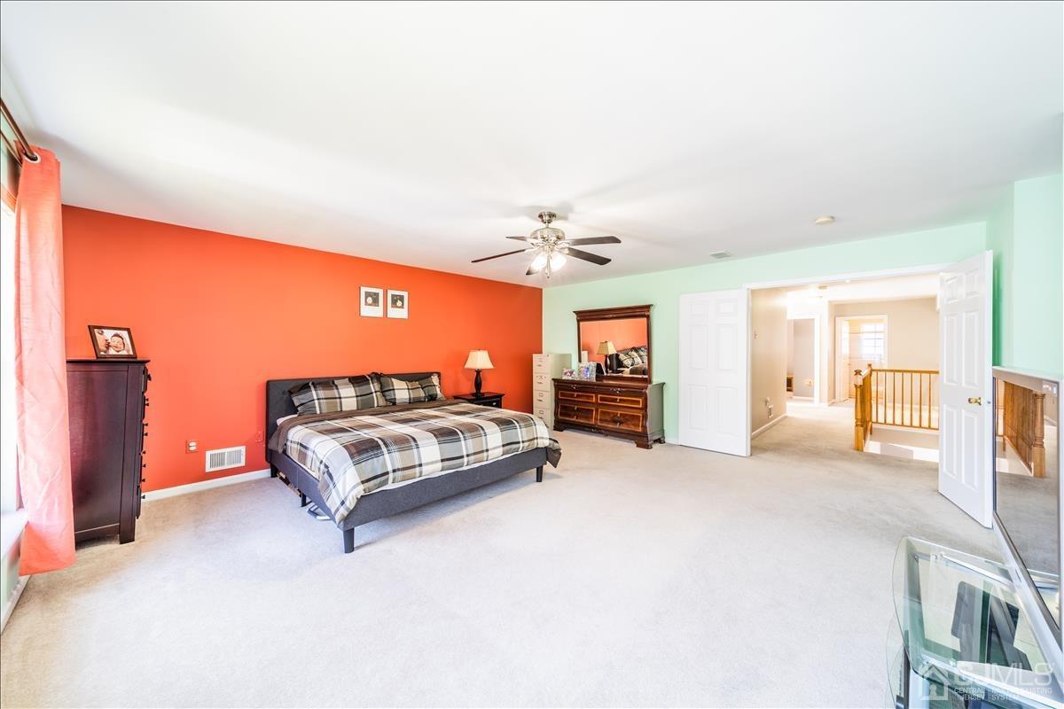 46 Potomac Road Monmouth Junction, NJ 08852 - Photo 23 of 42 a living room with furniture a flat screen tv and a chandelier