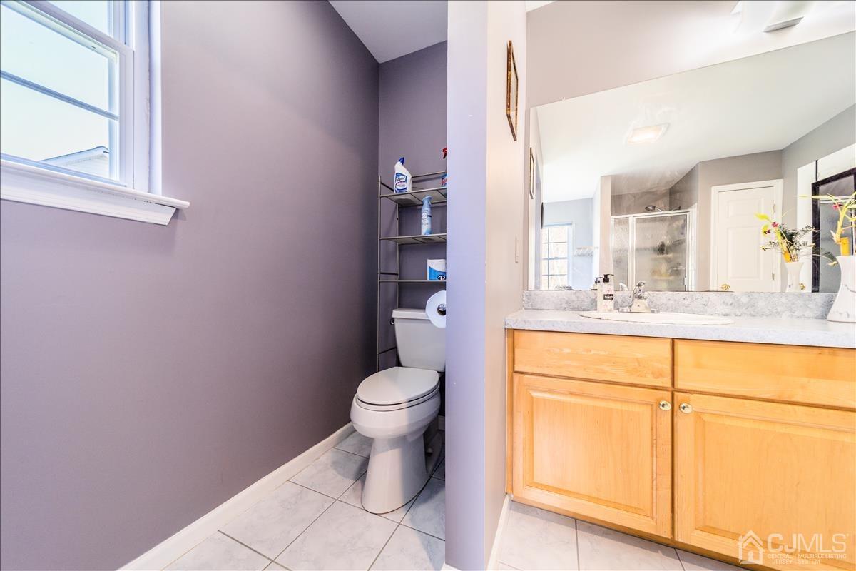 46 Potomac Road Monmouth Junction, NJ 08852 - Photo 26 of 42 a bathroom with a toilet sink a mirror and vanity
