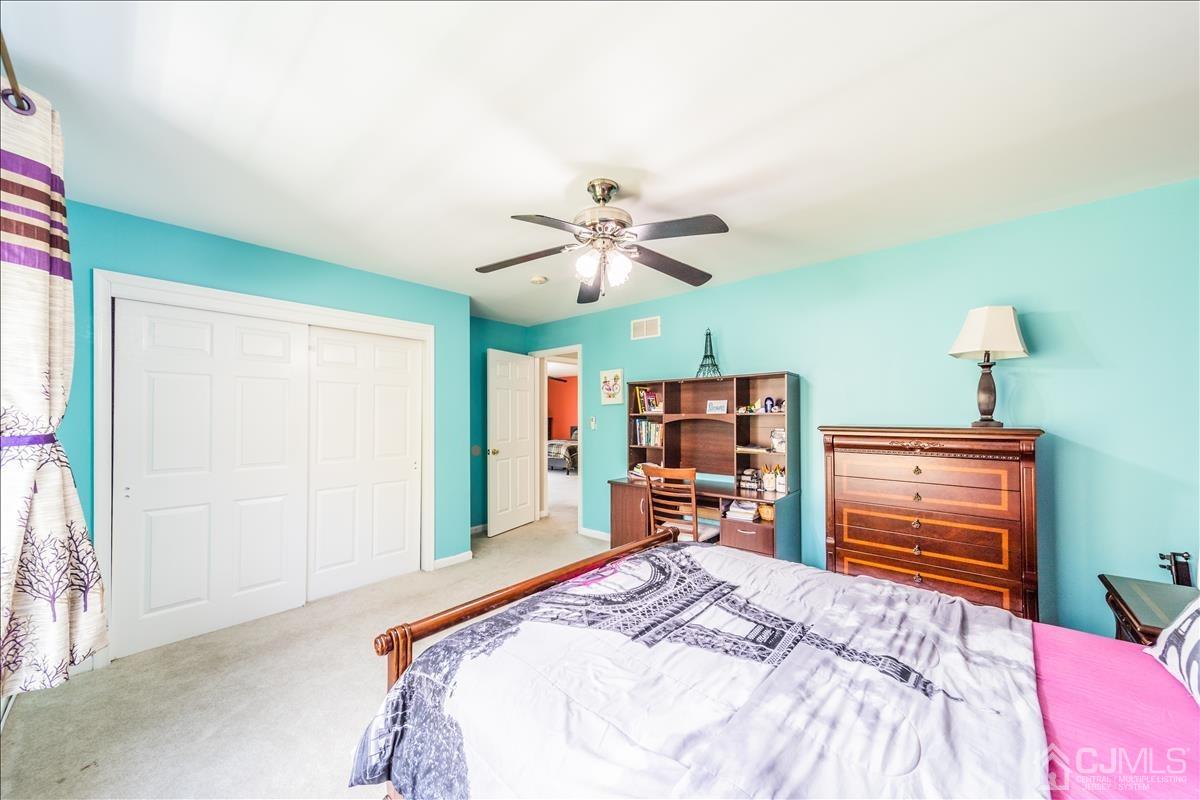46 Potomac Road Monmouth Junction, NJ 08852 - Photo 29 of 42 a bedroom with a bed and a chandelier