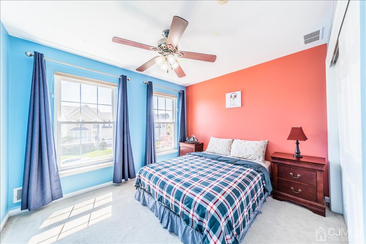 46 Potomac Road Monmouth Junction, NJ 08852 - Photo 30 of 42 a bedroom with a bed and a chandelier